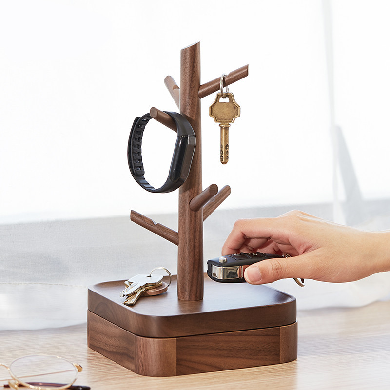 Nordic-style wooden key holder placed on a console table with accessories