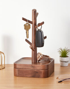 Nordic-style wooden key holder placed on a console table with accessories