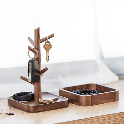 Nordic-style wooden key holder placed on a console table with accessories