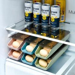 Egg storage box placed in fridge shelf with rolling eggs