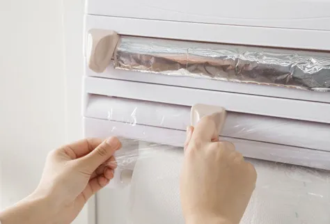 Wall-mounted kitchen wrap cutter and storage rack for foil, cling film, and paper towels