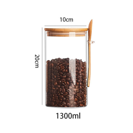 Transparent glass storage jar with wooden spoon and lid for kitchen pantry organizati